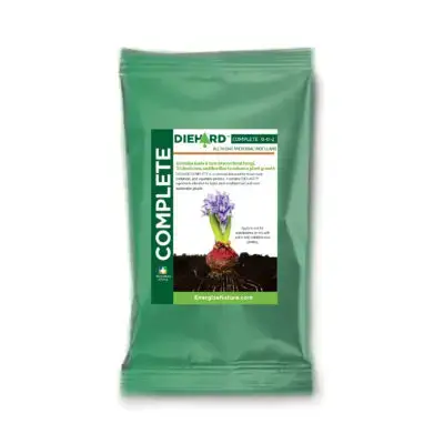 Granular mycorrhizal inoculant being applied to flower bed – DIEHARD COMPLETE promotes fast rooting, transplant recovery, and enhanced nutrient uptake in soil applications.